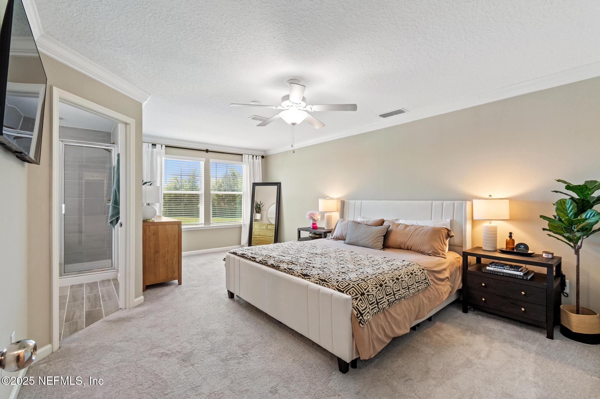 155 Appleton Court St. Augustine, FL 32092 - Photo 21 of 56 a bedroom with a bed and a chandelier