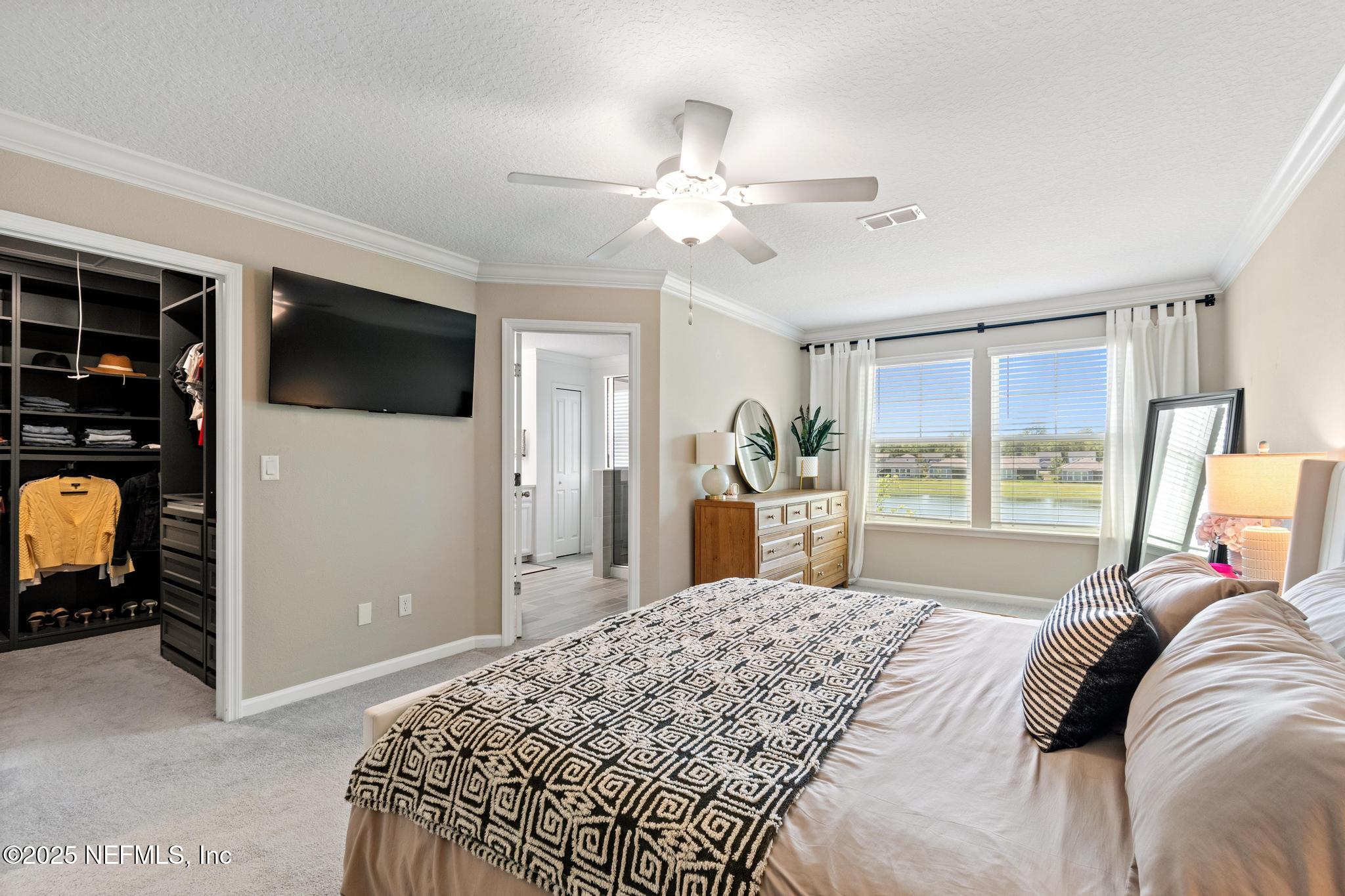 155 Appleton Court St. Augustine, FL 32092 - Photo 22 of 56 a bedroom with a bed and a flat tv screen on dresser