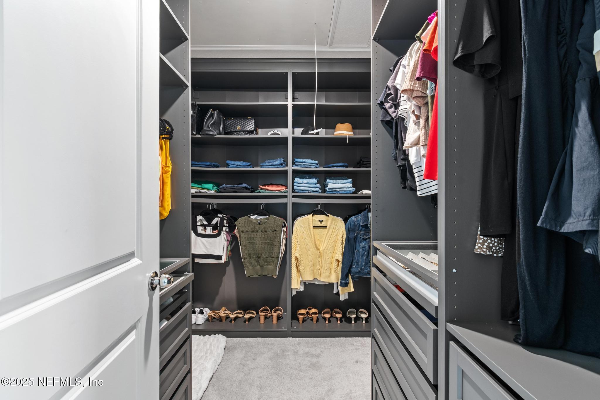 155 Appleton Court St. Augustine, FL 32092 - Photo 24 of 56 a view of walk in closet with clothes and shoes