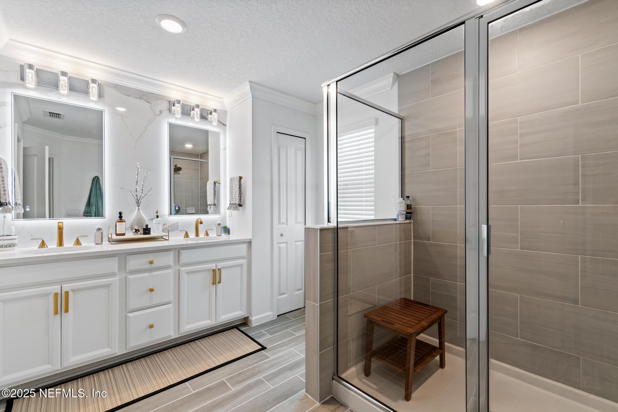 155 Appleton Court St. Augustine, FL 32092 - Photo 25 of 56 a bathroom with a double vanity sink a toilet and a mirror