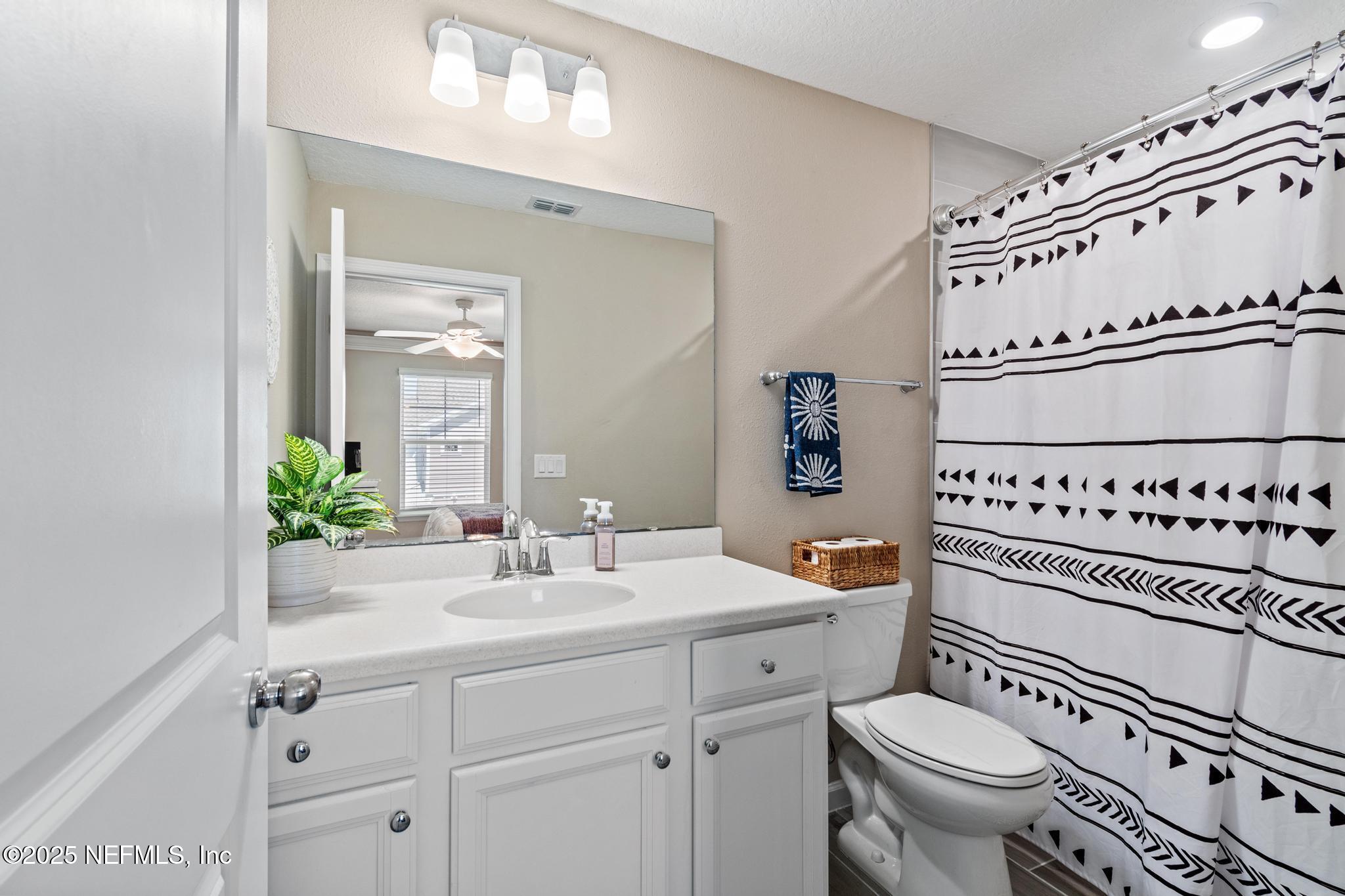 155 Appleton Court St. Augustine, FL 32092 - Photo 32 of 56 a bathroom with a sink a toilet and a mirror