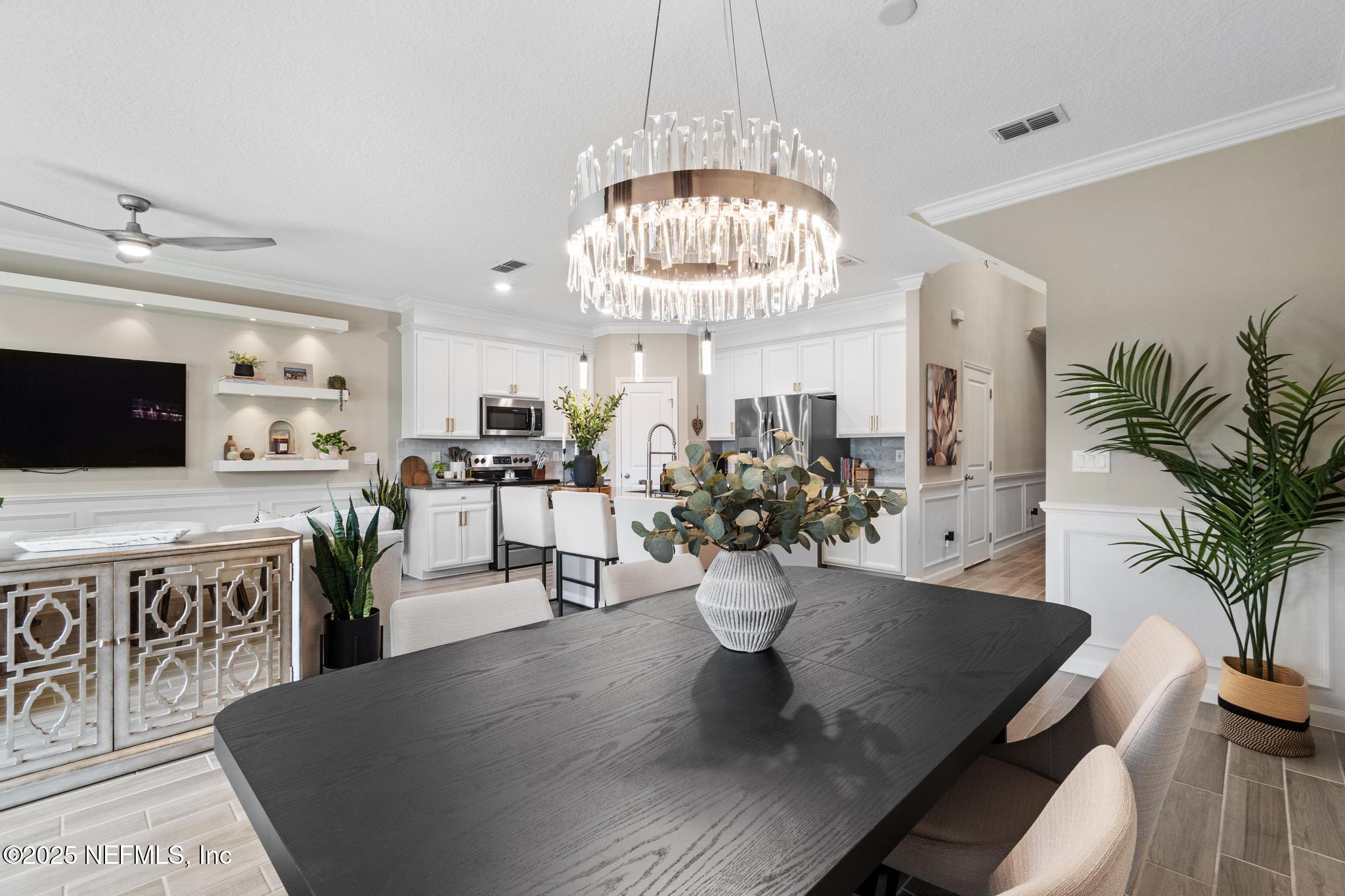 155 Appleton Court St. Augustine, FL 32092 - Photo 6 of 56 a view of a dining room with furniture a chandelier and kitchen view