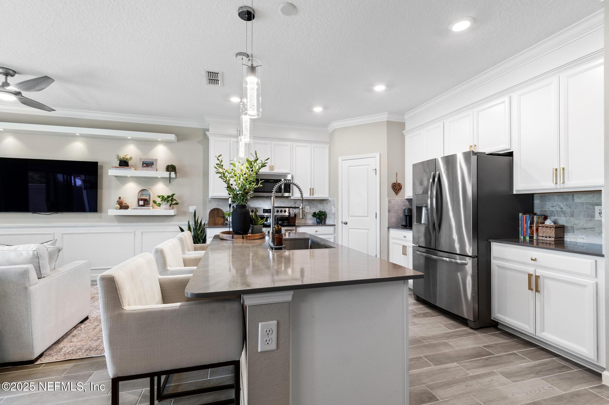 155 Appleton Court St. Augustine, FL 32092 - Photo 10 of 56 a kitchen with refrigerator and chairs