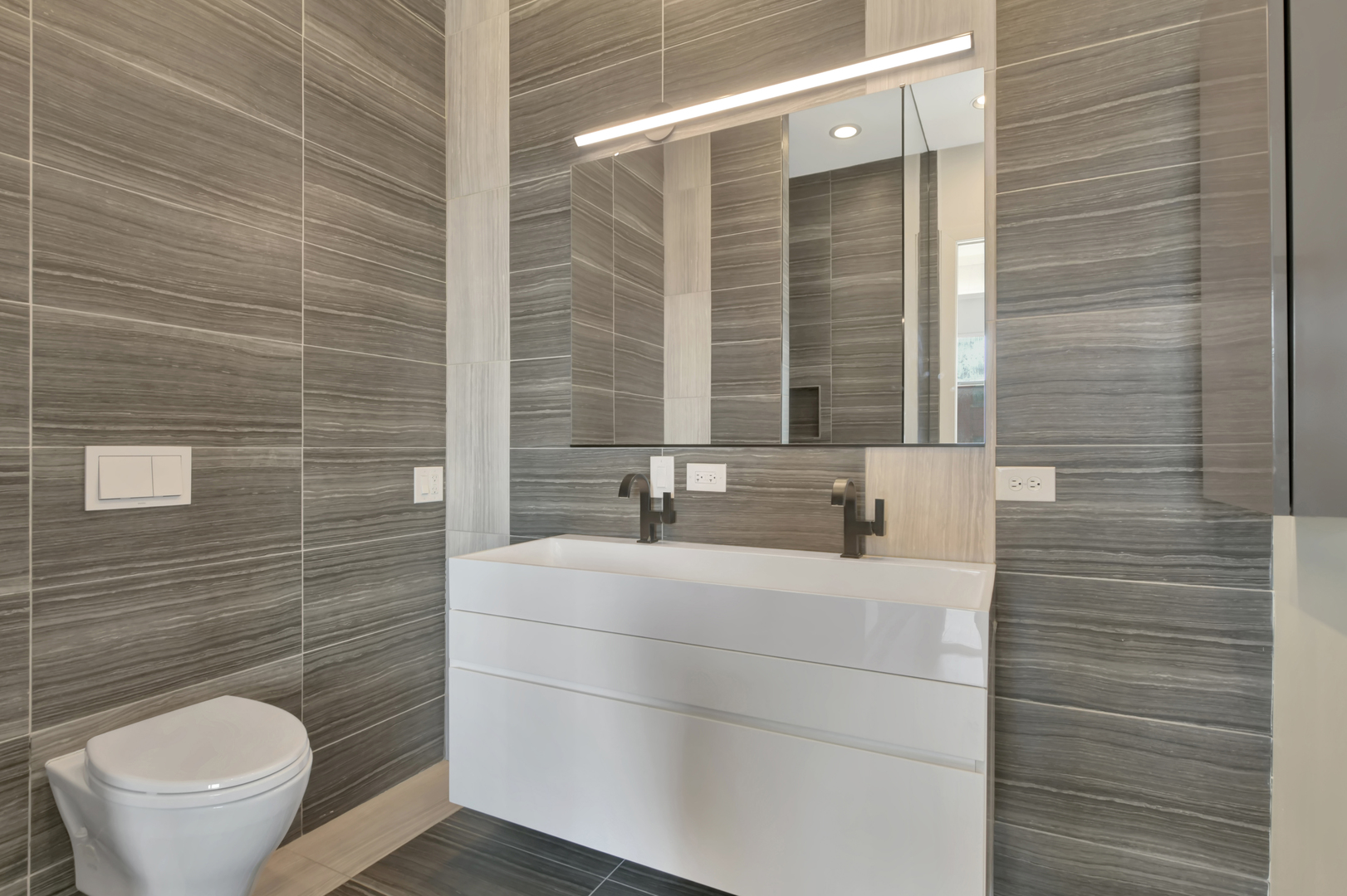 812 West Van Buren Street, Unit 5A Chicago, IL 60607 - Photo 14 of 26 a bathroom with a sink a toilet and mirror