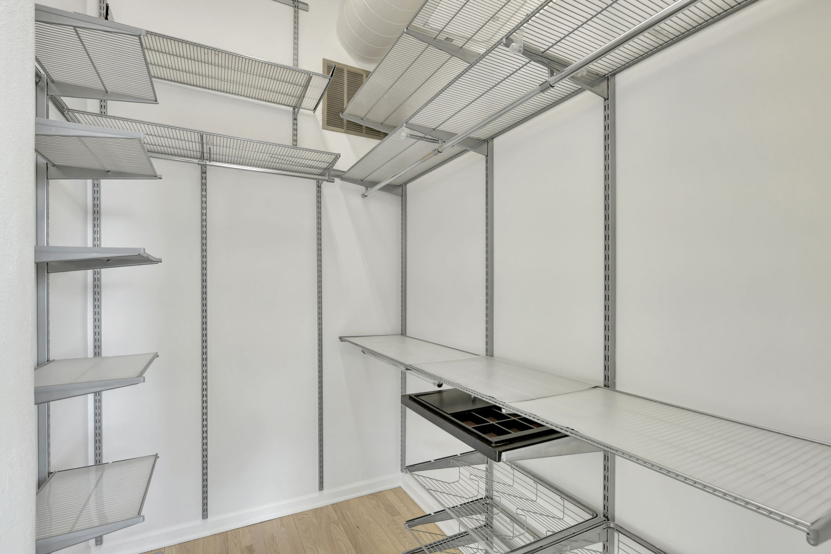 812 West Van Buren Street, Unit 5A Chicago, IL 60607 - Photo 16 of 26 a view of a room with wooden floor and cabinets