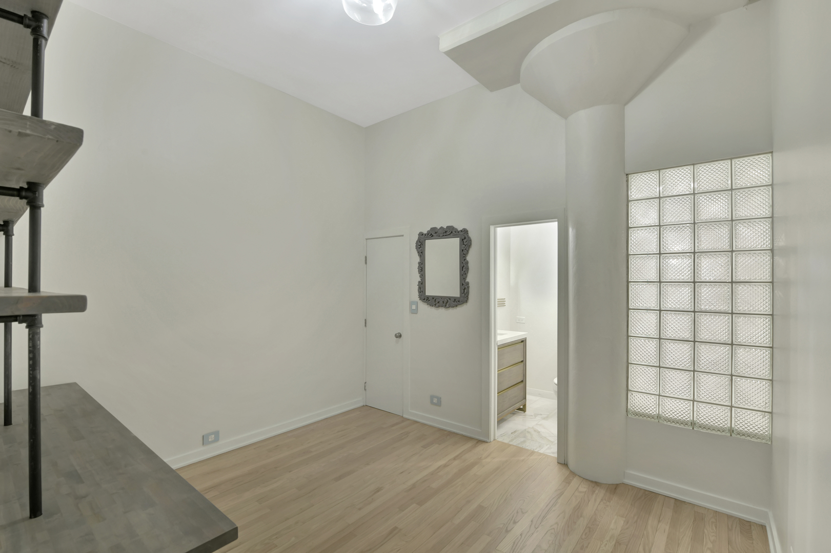 812 West Van Buren Street, Unit 5A Chicago, IL 60607 - Photo 20 of 26 an empty room with wooden floor and cabinet