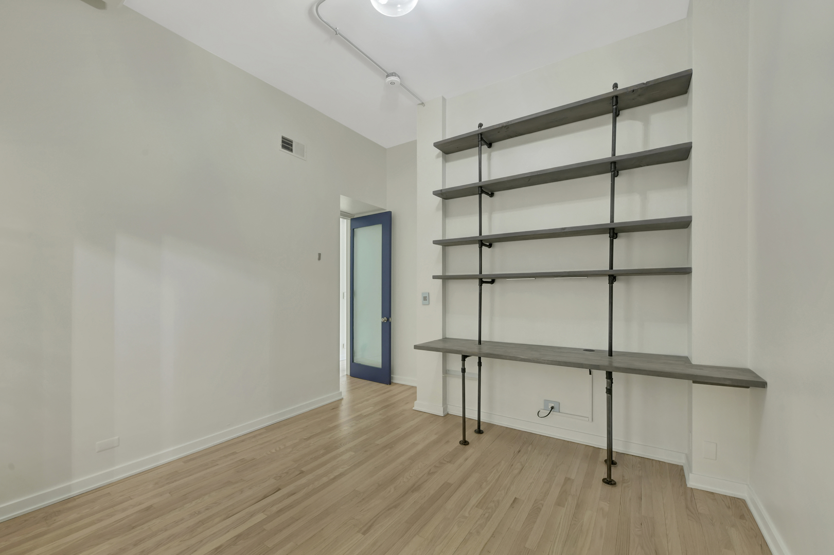 812 West Van Buren Street, Unit 5A Chicago, IL 60607 - Photo 21 of 26 a view of an empty room with wooden floor and a window