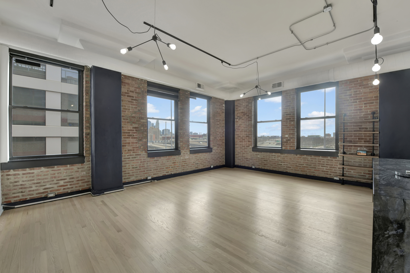 812 West Van Buren Street, Unit 5A Chicago, IL 60607 - Photo 3 of 26 a view of an empty room with a window and wooden floor