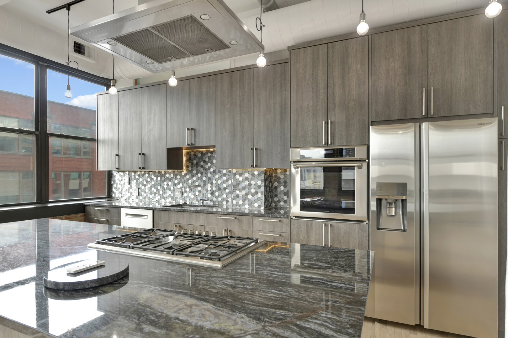 812 West Van Buren Street, Unit 5A Chicago, IL 60607 - Photo 9 of 26 a kitchen with a stove a refrigerator and cabinets