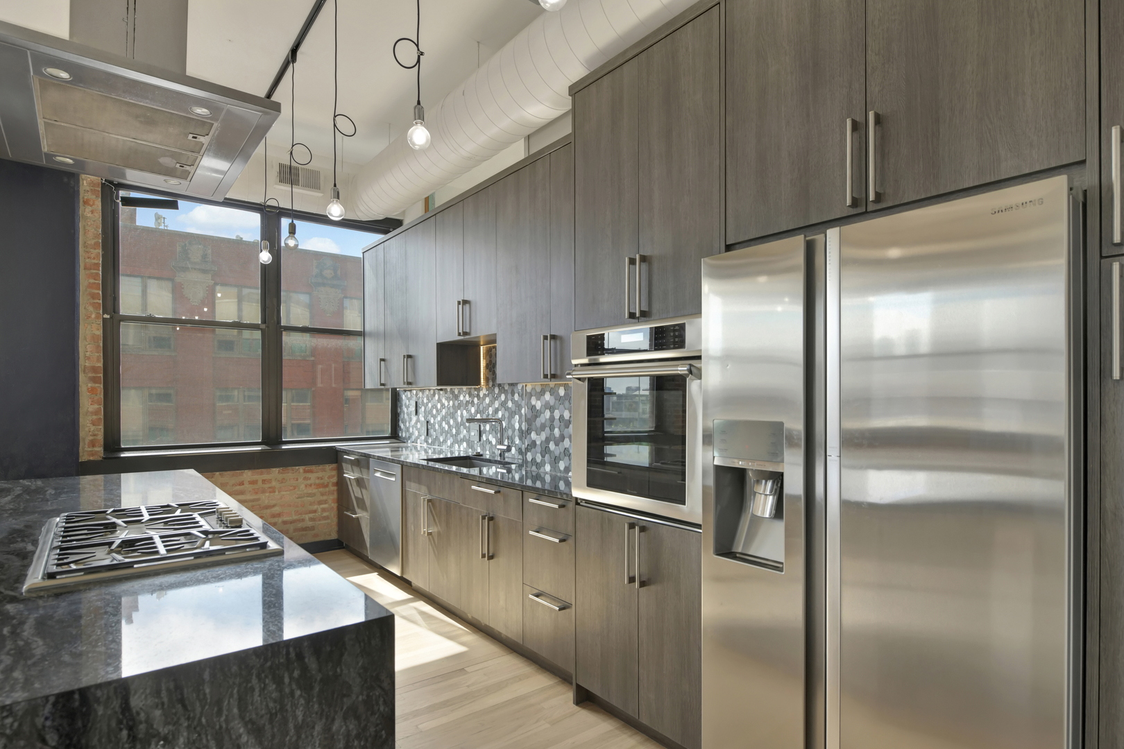 812 West Van Buren Street, Unit 5A Chicago, IL 60607 - Photo 10 of 26 a kitchen with stainless steel appliances granite countertop a refrigerator and a stove