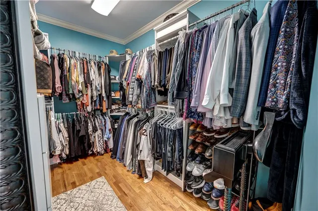 a view of a hallway with workspace and wooden floor