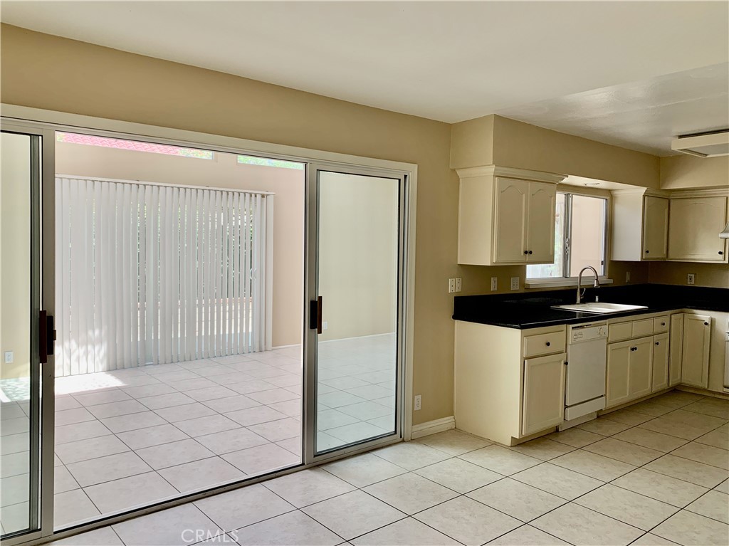 15 Butler Street Irvine, CA 92612 - Photo 11 of 37 a bathroom with a granite countertop sink and a mirror