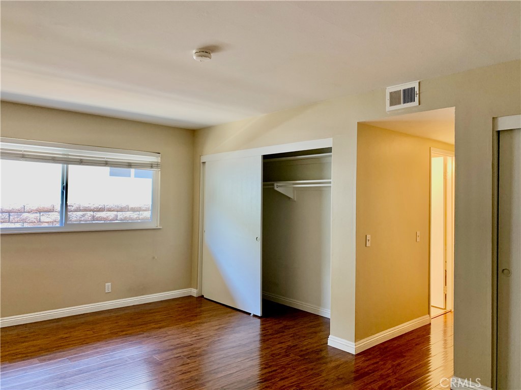 15 Butler Street Irvine, CA 92612 - Photo 14 of 37 an empty room with wooden floor and a window
