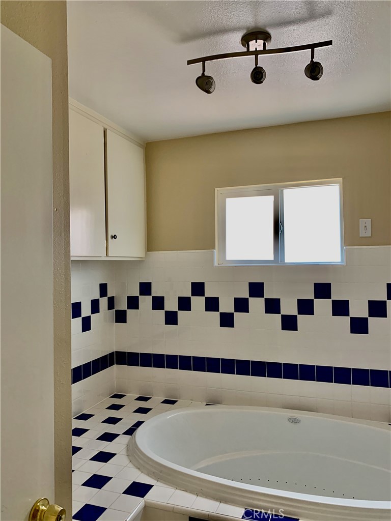 15 Butler Street Irvine, CA 92612 - Photo 17 of 37 a bathroom with a bathtub and a shower