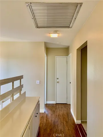 a view of hallway with wooden floor
