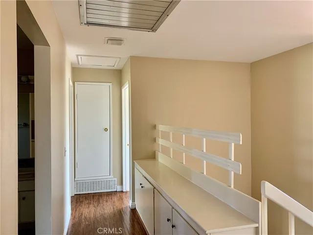 a view of walk in closet with wooden floor