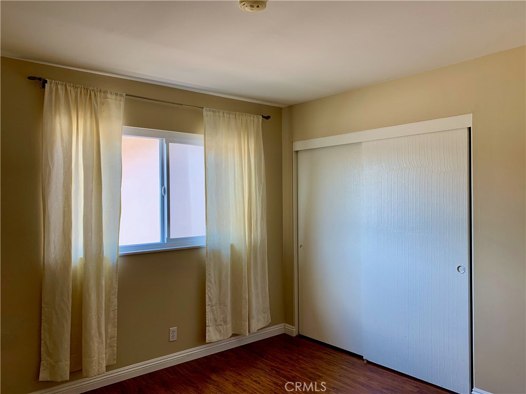 15 Butler Street Irvine, CA 92612 - Photo 28 of 37 a view of an empty room with wooden floor and a window