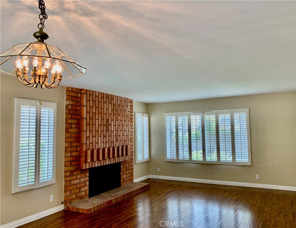 15 Butler Street Irvine, CA 92612 - Photo 7 of 37 a view of an empty room with wooden floor and a window