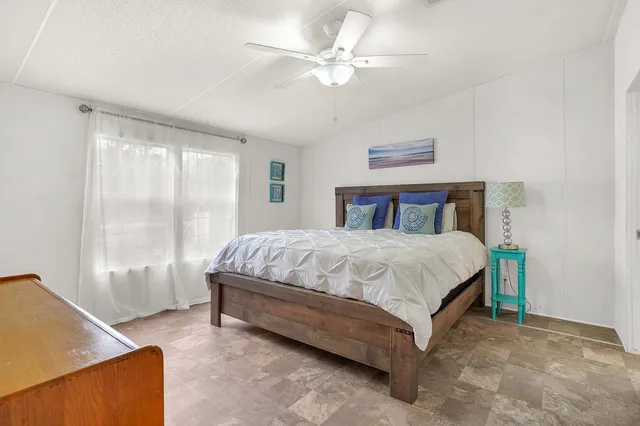 a spacious bedroom with a bed and a window