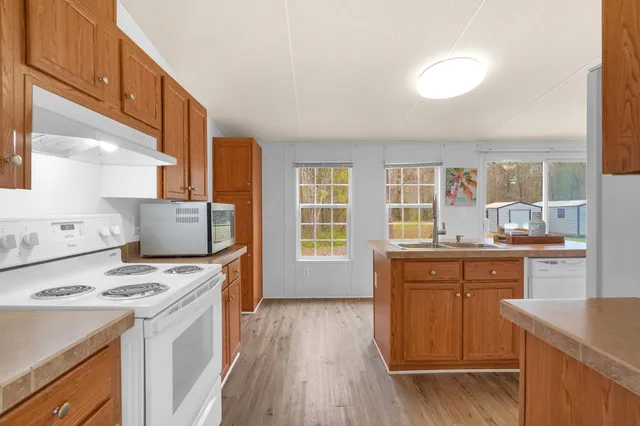 a kitchen with a stove a sink and a refrigerator