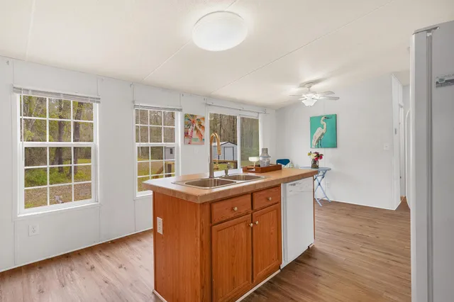 a kitchen with a stove and wooden floor