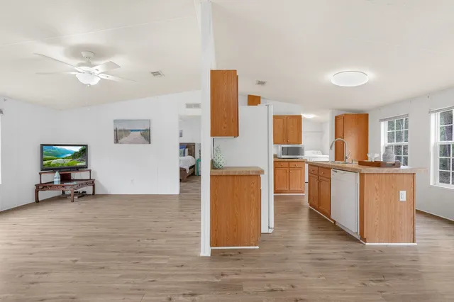 a view of kitchen with furniture and wooden floor