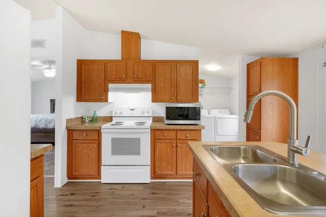 a kitchen with stainless steel appliances granite countertop a sink stove and refrigerator