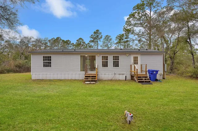 a view of a house with backyard and porch