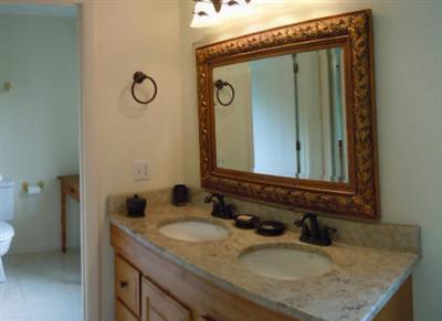 208 Huckins Neck Road Centerville, MA 02601 - Photo 11 of 12 a bathroom with a granite countertop sink and a mirror