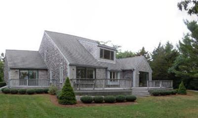 208 Huckins Neck Road Centerville, MA 02601 - Photo 3 of 12 a front view of a house with a yard