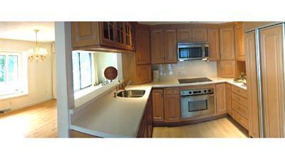 208 Huckins Neck Road Centerville, MA 02601 - Photo 5 of 12 a kitchen with a stove a microwave and a counter top space