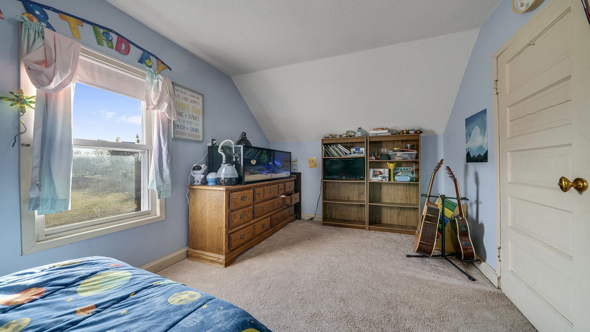 4738 Owen Center Road Rockford, IL 61101 - Photo 13 of 42 a bed room with a bed and a window