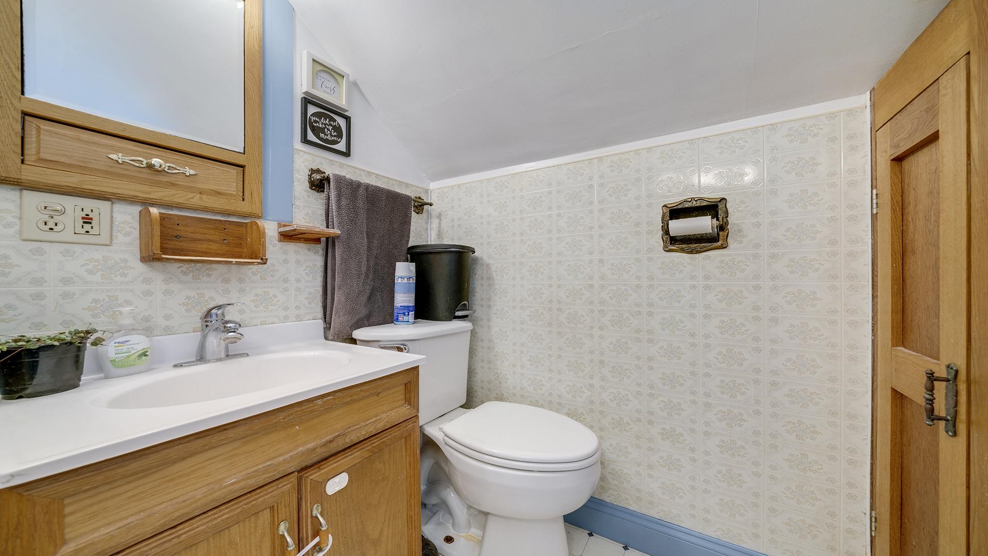 4738 Owen Center Road Rockford, IL 61101 - Photo 15 of 42 a bathroom with a toilet a sink and mirror