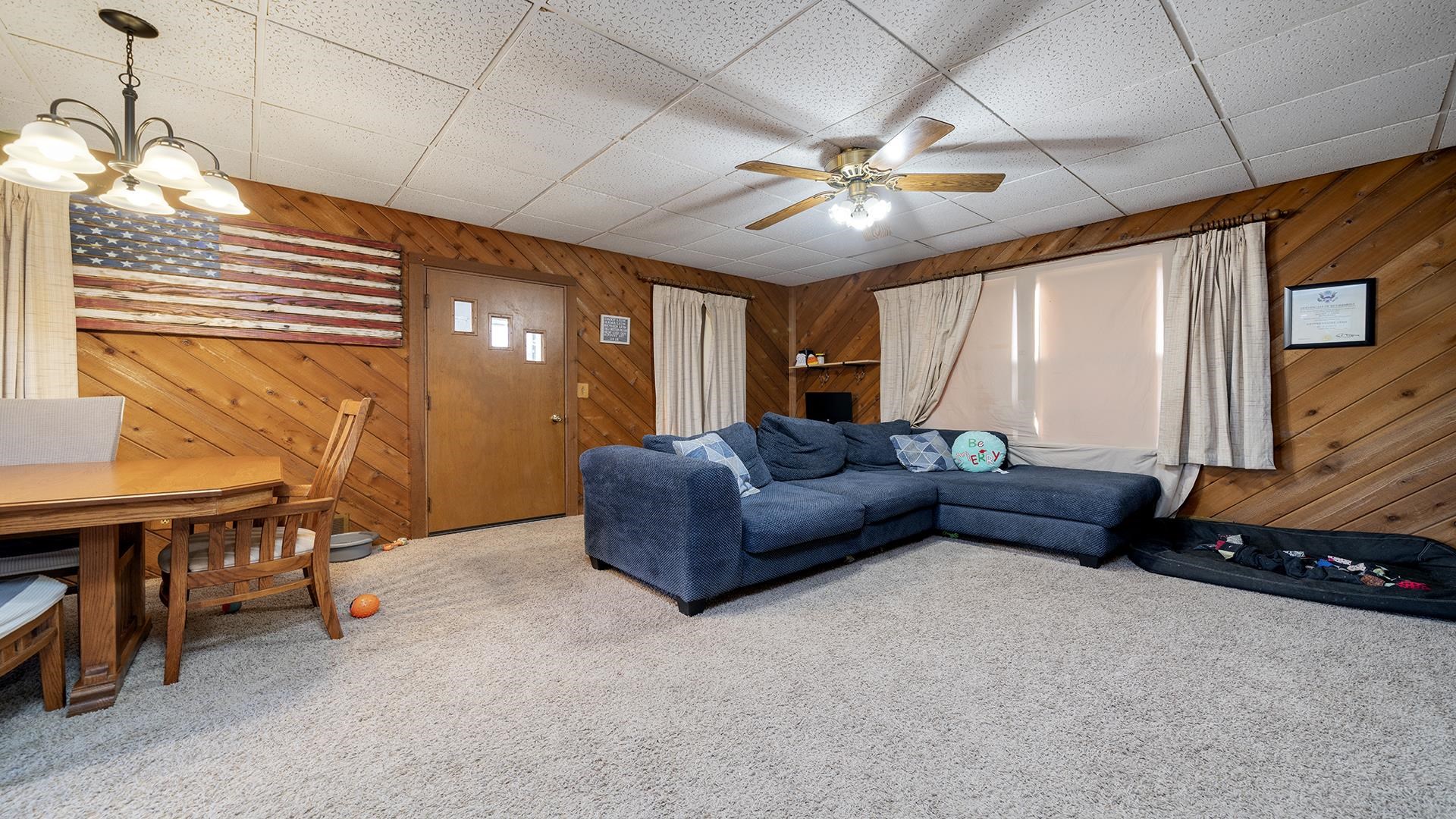 4738 Owen Center Road Rockford, IL 61101 - Photo 6 of 42 a living room with furniture and a chandelier