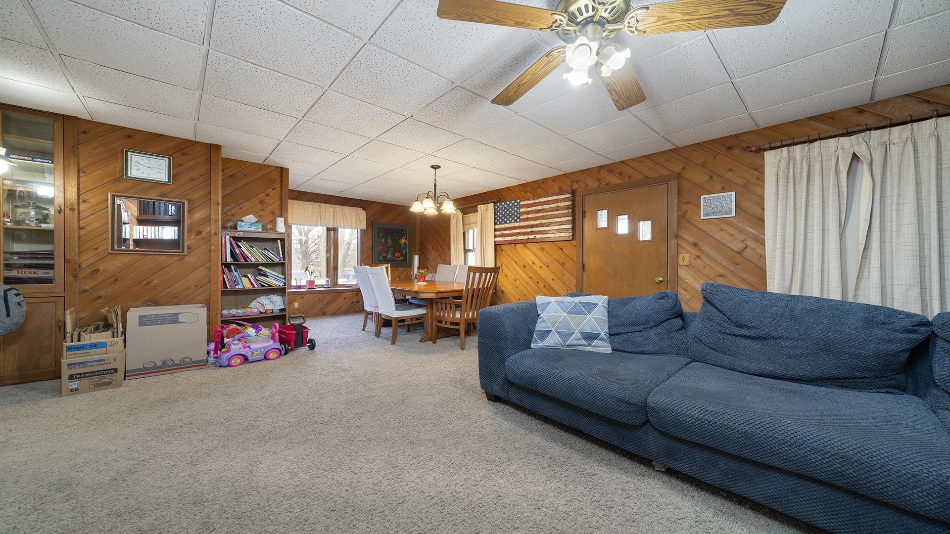 4738 Owen Center Road Rockford, IL 61101 - Photo 7 of 42 a living room with furniture a couch and a chandelier