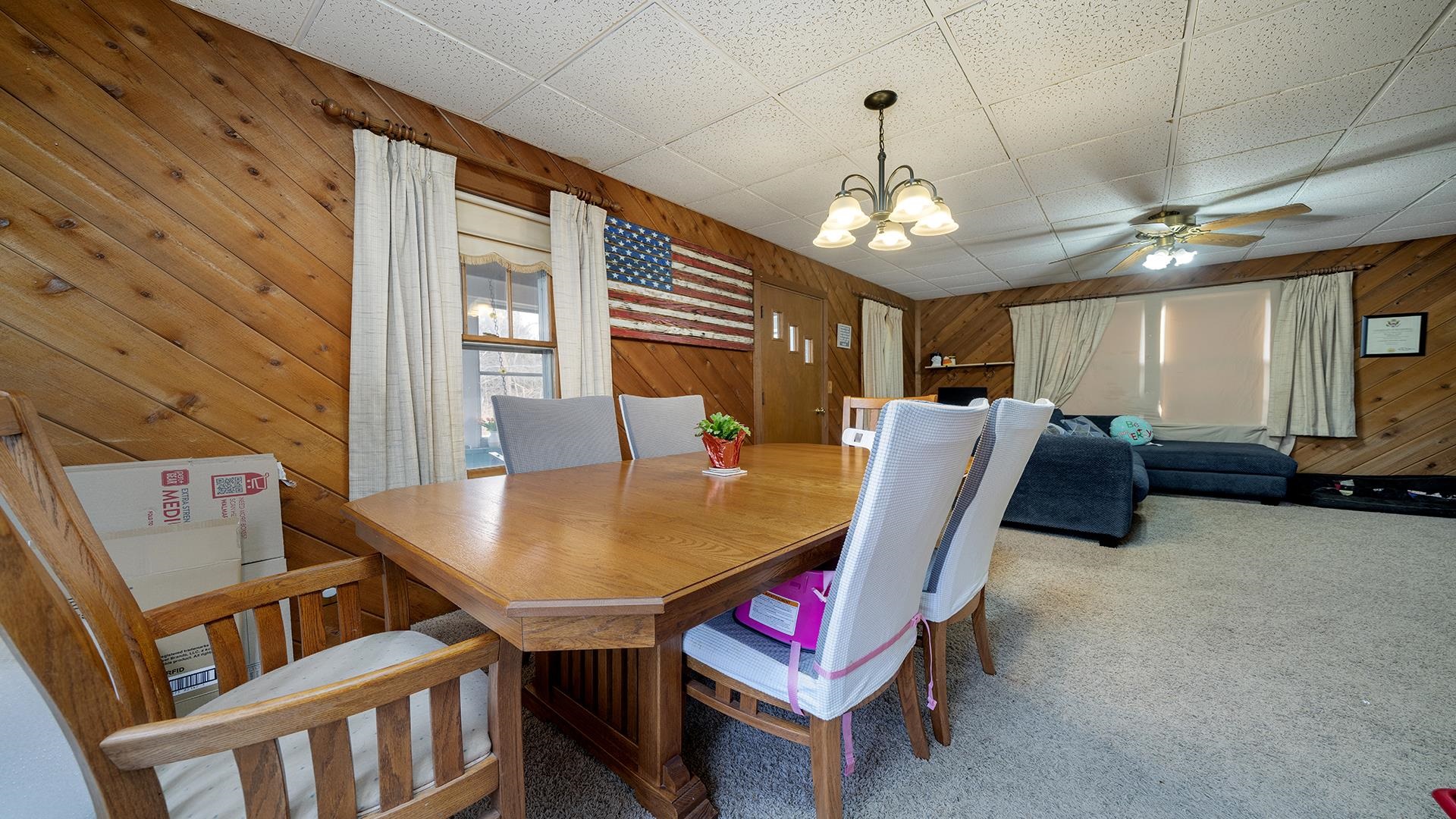 4738 Owen Center Road Rockford, IL 61101 - Photo 9 of 42 a living room with furniture a chandelier and a flat screen tv