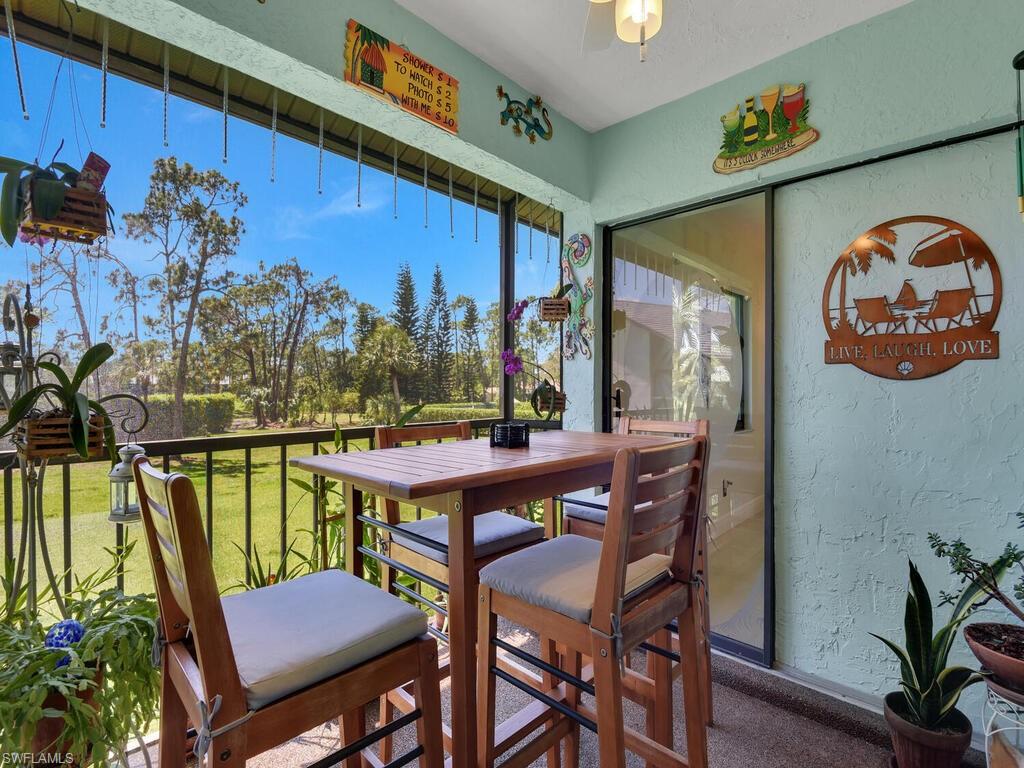 5825 Rattlesnake Hammock Road, Unit 202 Naples, FL 34113 - Photo 12 of 30 a view of a chairs and table in a balcony