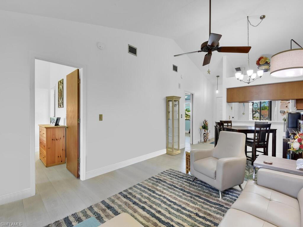 5825 Rattlesnake Hammock Road, Unit 202 Naples, FL 34113 - Photo 30 of 30 a living room with furniture and a chandelier