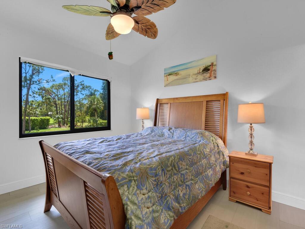 5825 Rattlesnake Hammock Road, Unit 202 Naples, FL 34113 - Photo 19 of 30 a bedroom with a bed and a window