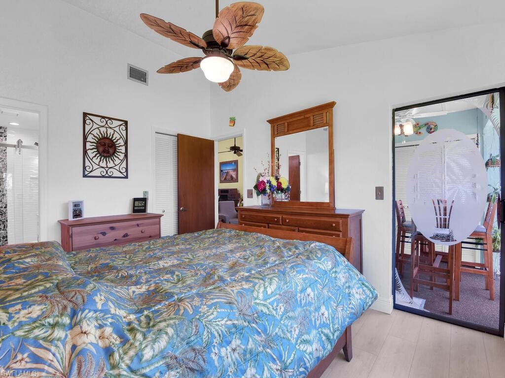 5825 Rattlesnake Hammock Road, Unit 202 Naples, FL 34113 - Photo 20 of 30 a bedroom with a bed and dresser with mirror