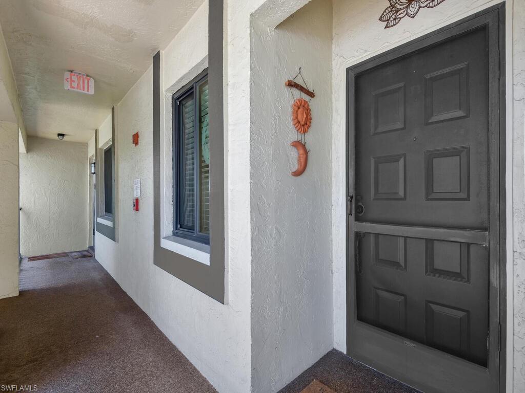 5825 Rattlesnake Hammock Road, Unit 202 Naples, FL 34113 - Photo 4 of 30 a hallway with front door