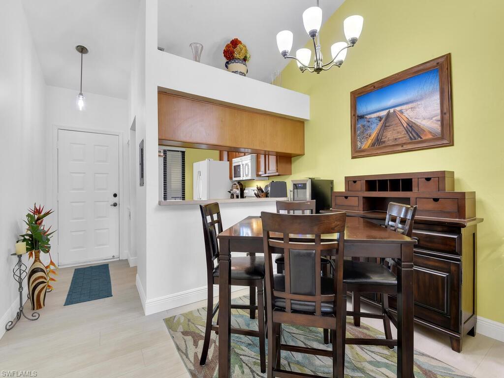 5825 Rattlesnake Hammock Road, Unit 202 Naples, FL 34113 - Photo 7 of 30 a view of a dining room with furniture