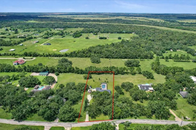 an aerial view of huge green field with lots of green plants in it
