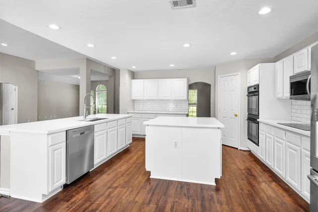 a kitchen with kitchen island granite countertop a stove microwave and refrigerator