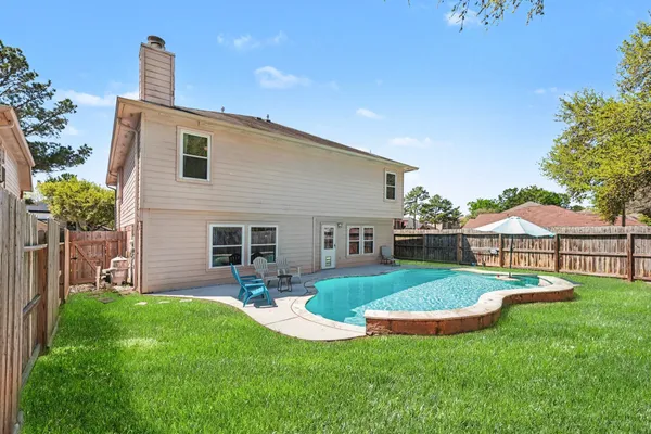 a view of a house with a yard and sitting area