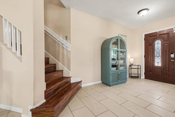 a view of a workspace with furniture and a window