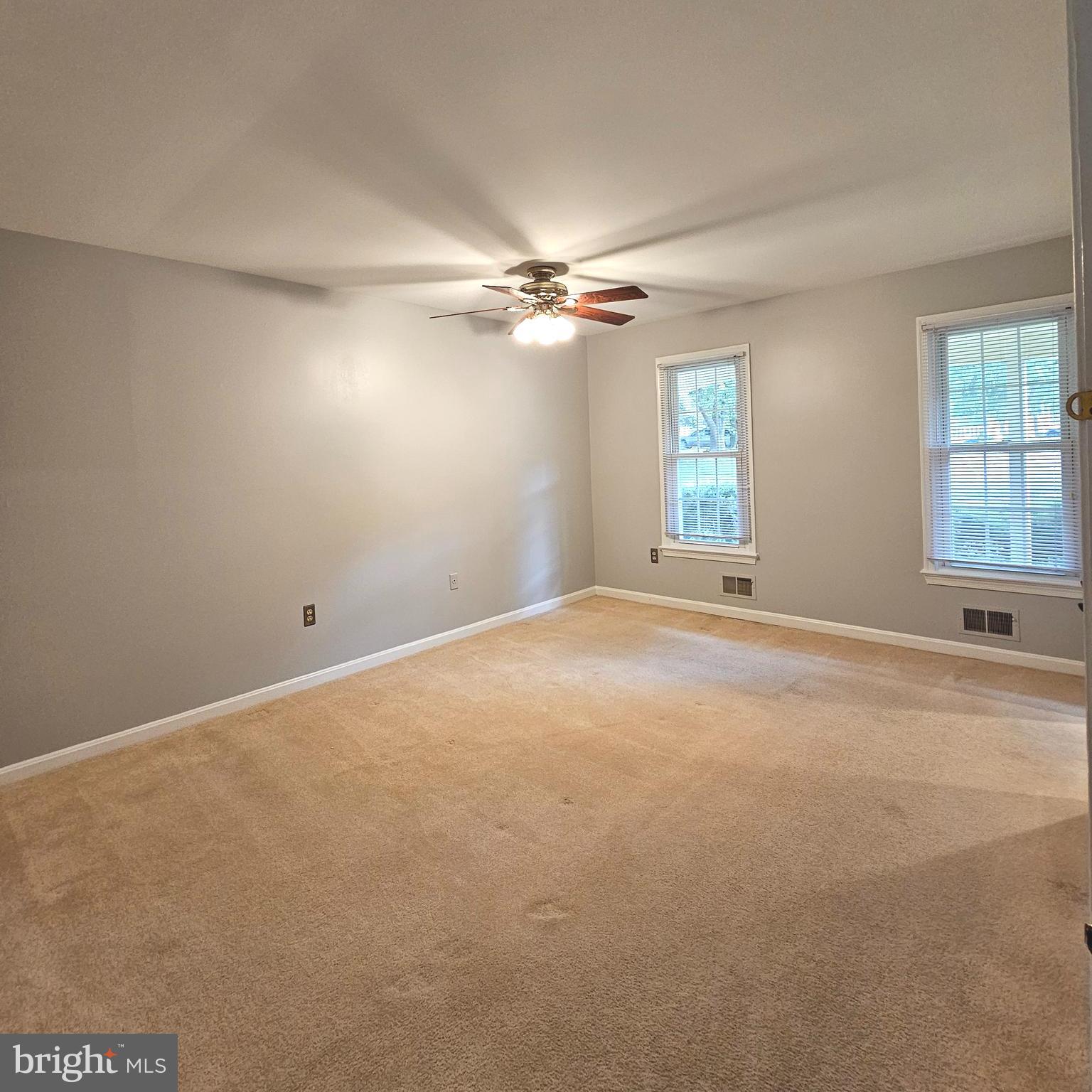 7777 Turlock Road Springfield, VA 22153 - Photo 13 of 43 an empty room with chandelier fan and windows