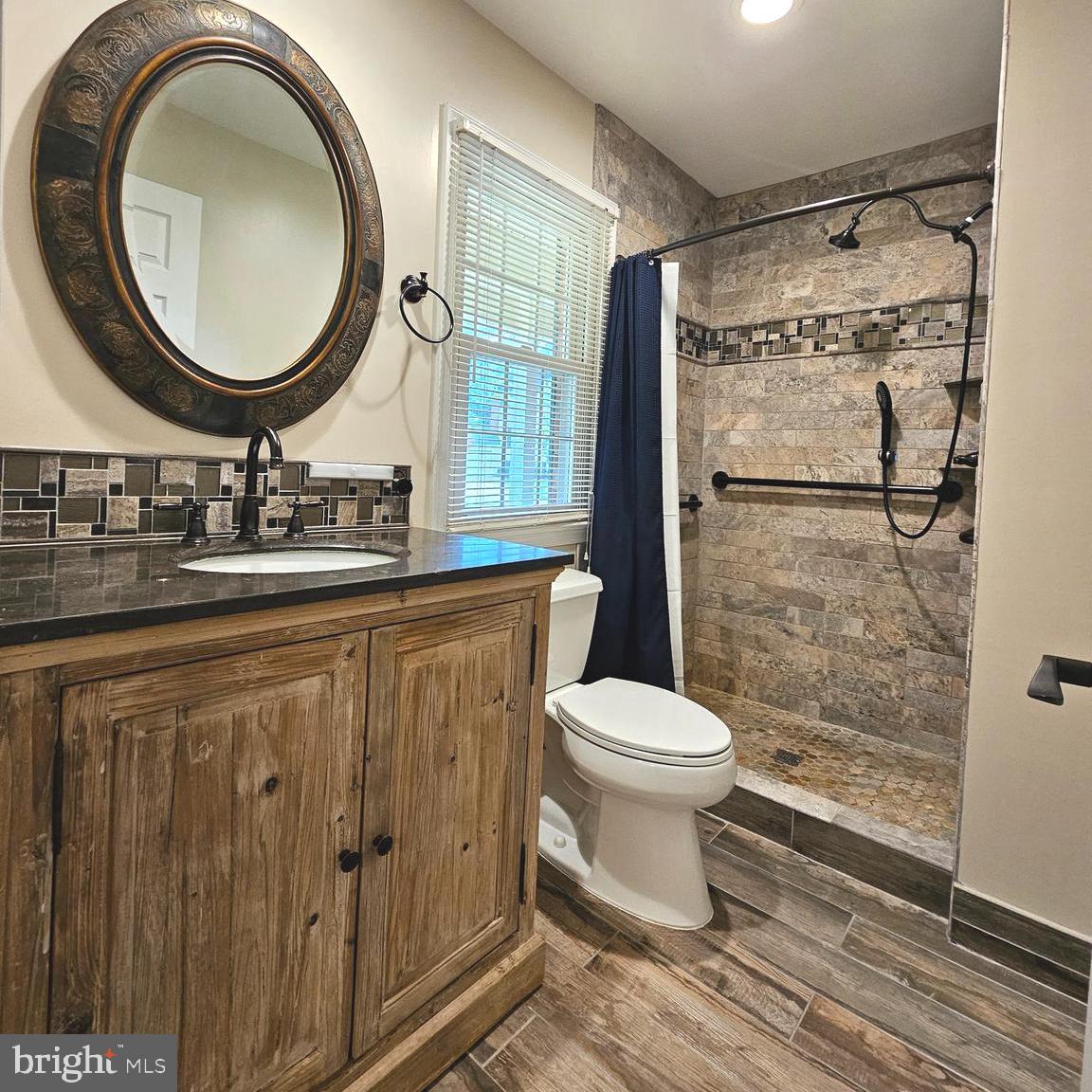 7777 Turlock Road Springfield, VA 22153 - Photo 15 of 43 a bathroom with a toilet a sink and a mirror