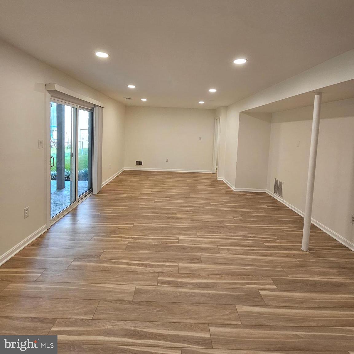 7777 Turlock Road Springfield, VA 22153 - Photo 25 of 43 a view of an empty room with wooden floor and a window