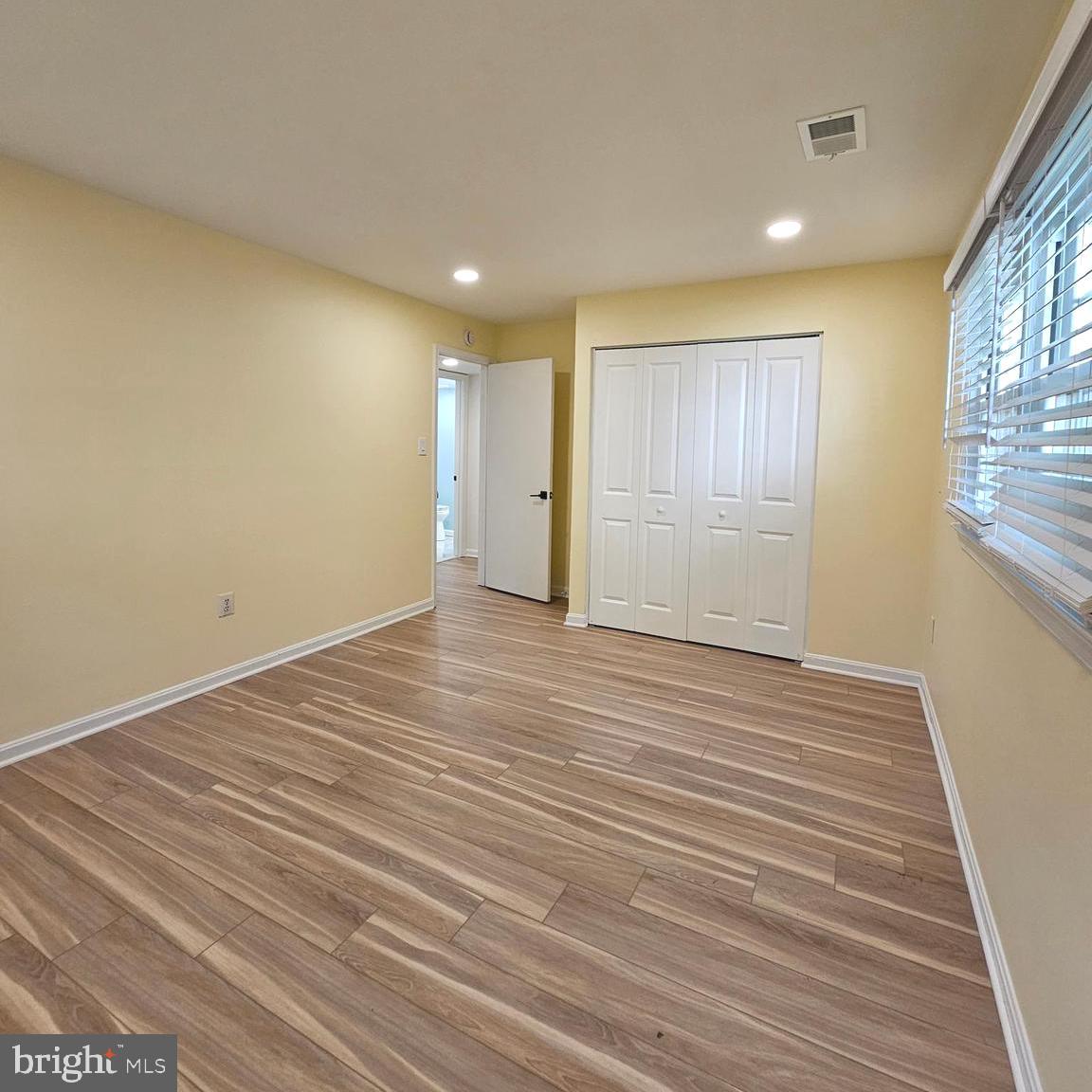 7777 Turlock Road Springfield, VA 22153 - Photo 28 of 43 wooden floor in an empty room with a window